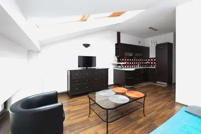 a living room with a couch and a table at Komfortowy apartament z klimatyzacją in Kraków