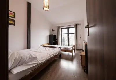 a bedroom with two beds and a window at Komfortowy apartament z klimatyzacją in Kraków
