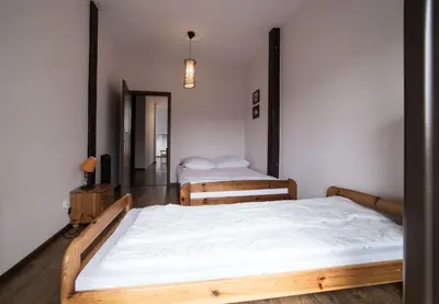 a bedroom with two beds and a mirror at Komfortowy apartament z klimatyzacją in Kraków