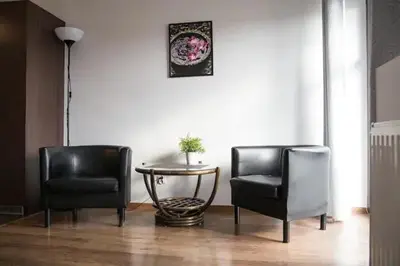 two chairs and a table in a living room at Przytulny apartament Kos w sercu Krakowa in Kraków