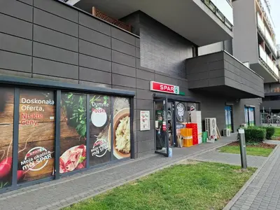a fast food restaurant with signs on the side of a building at Bagry Rooms2 - Apartament z sypialnią i miejscem postojowym in Kraków