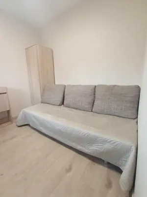a bed in a white room with at Blisko Energylandii in Zator