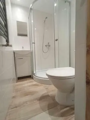 a white bathroom with a shower and a toilet at Blisko Energylandii in Zator