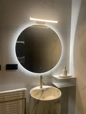 a bathroom with a sink and a mirror at Apartamenty 91 in Spytkowice