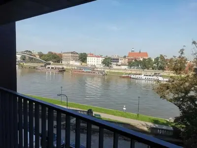 a view of a river from a balcony at Apartament z widokiem na Wisłę in Kraków
