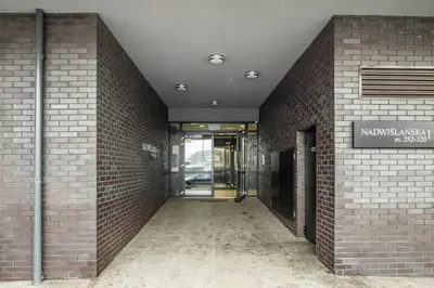 an entrance to a building with a brick wall at Apartament z widokiem na Wisłę in Kraków