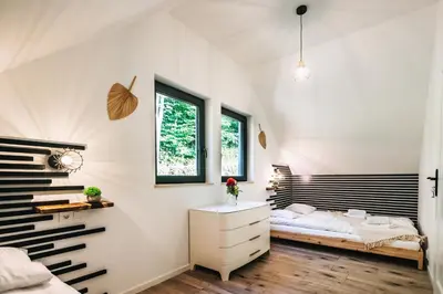 a bedroom with a bed and a desk at Zawoja House in Zawoja