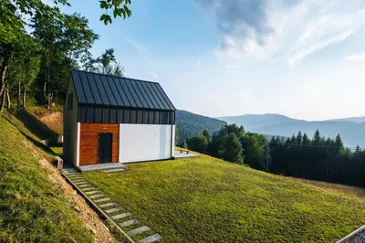 a small house on top of a grassy hill at Zawoja House in Zawoja