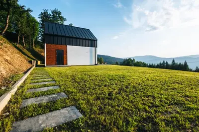a small house on top of a grassy hill at Zawoja House in Zawoja