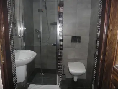a bathroom with a sink and a toilet and a shower at Apartamenty Astur in Kraków