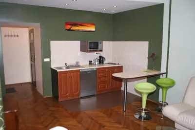 a kitchen with a sink and a table at Apartamenty Astur in Kraków