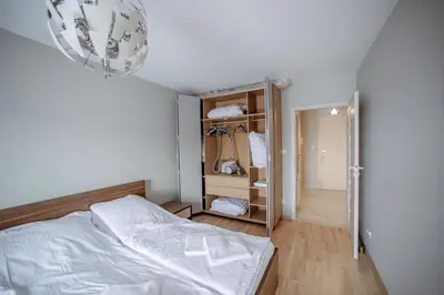 a small bedroom with a bed and a closet at Apartament Jana 14 z garażem podziemnym in Bochnia