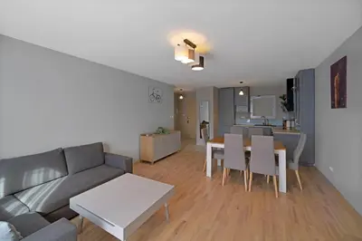 a living room with a couch and a table at Apartament Jana 14 z garażem podziemnym in Bochnia