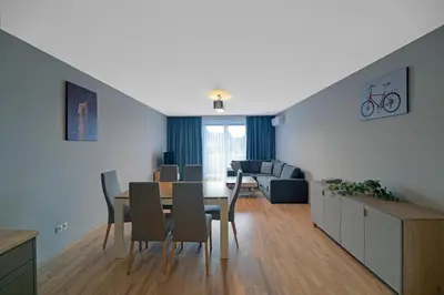 a living room and dining room with a table and chairs at Apartament Jana 14 z garażem podziemnym in Bochnia