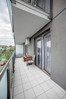 a balcony with a table and a desk on a building at Apartament Jana 14 z garażem podziemnym in Bochnia