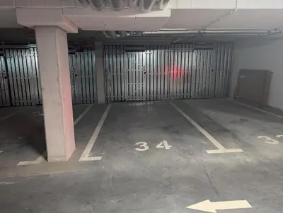 an empty parking garage with a red car in it at Bagry Lake Apartment in Kraków