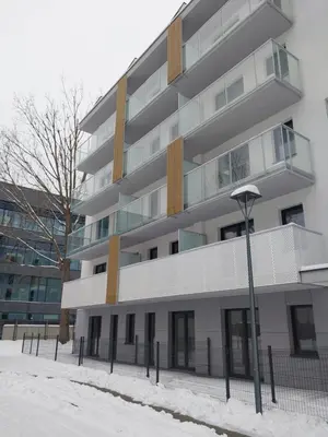 an apartment building with snow in front of it at Bagry Lake Apartment in Kraków