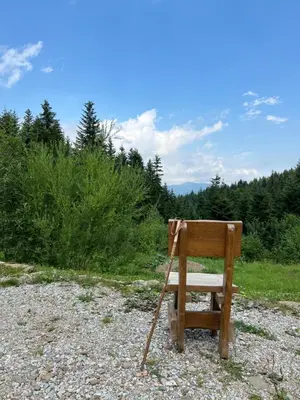 a wooden picnic table in front of a cabin at Górska Osada Śleboda in Zasadne
