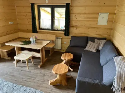 a wooden table in a log cabin with a kitchen at Górska Osada Śleboda in Zasadne