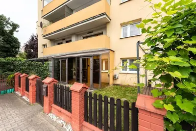 a house with a fence in front of it at Apartament PARYSKI 4 pokoje 90m2 2 poziomy Ogród Oranżeria in Kraków