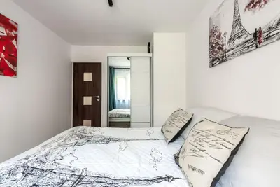 a white bedroom with a bed with two pillows at Apartament PARYSKI 4 pokoje 90m2 2 poziomy Ogród Oranżeria in Kraków