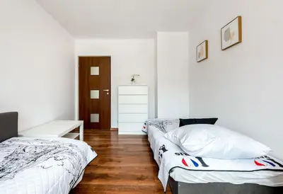 a bedroom with two beds and a desk in it at Apartament PARYSKI 4 pokoje 90m2 2 poziomy Ogród Oranżeria in Kraków