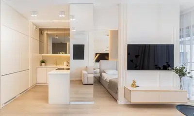 a living room with a bed and a tv at Glossy Apart G30 in Kraków