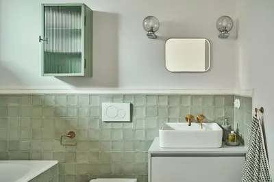 a white bathroom with a sink and a mirror at Blisko in Wieprz
