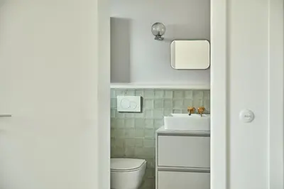 a bathroom with a white toilet and a sink at Blisko in Wieprz