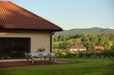 a table and chairs on the patio of a house at Blisko in Wieprz