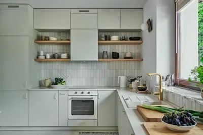 a white kitchen with white cabinets and a sink at Blisko in Wieprz