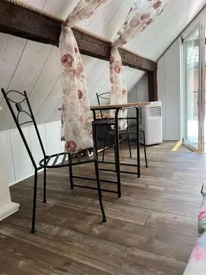 a room with two chairs and a table with curtains at Dziupla in Wygiełzów