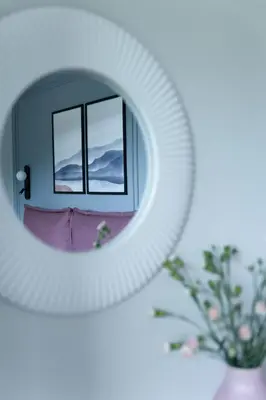 a mirror with a reflection of a window at Heima in Zawoja