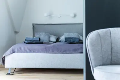 a bedroom with a bed and a chair at Heima in Zawoja