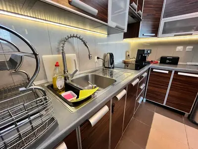 a kitchen counter with a sink and a sink at Cracow Stay Premium Apartments FREE PARKING - 3 x ROOM - 3 x AIRCONDITION in Kraków