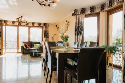 a dining room with a table and chairs at Zagornik in Inwałd