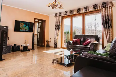 a living room with a couch and a table at Zagornik in Inwałd