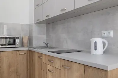 a kitchen with a sink and a microwave at Studio apartment with balcony - Starowiślna 41 in Kraków