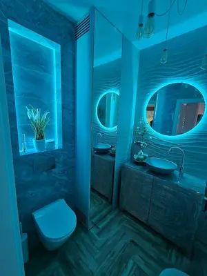 a blue bathroom with a toilet and a sink at Apartament Podedworze in Bochnia