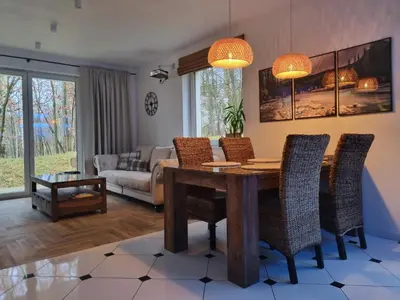 a living room with a wooden table and chairs at Apartament Podedworze in Bochnia