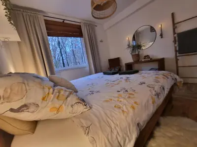 a bedroom with a large bed and a window at Apartament Podedworze in Bochnia