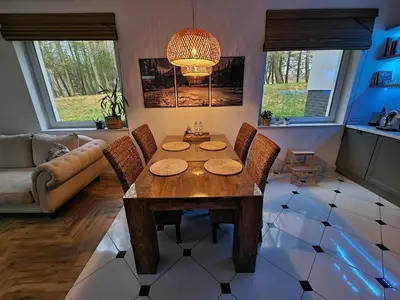 a living room with a wooden table and chairs at Apartament Podedworze in Bochnia