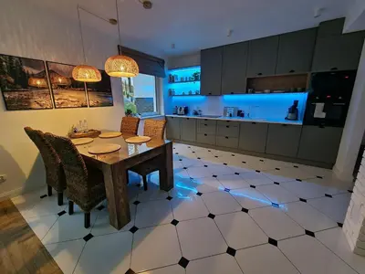 a kitchen with a table and chairs in a room at Apartament Podedworze in Bochnia