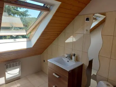 a bathroom with a sink and a window at WhyDeer in Wola Radziszowska