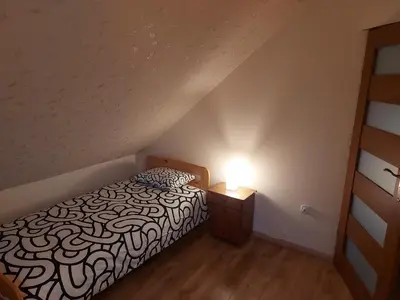 a bedroom with a black and white bed in a attic at WhyDeer in Wola Radziszowska