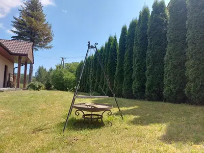 a swing in a grassy field with a table at WhyDeer in Wola Radziszowska