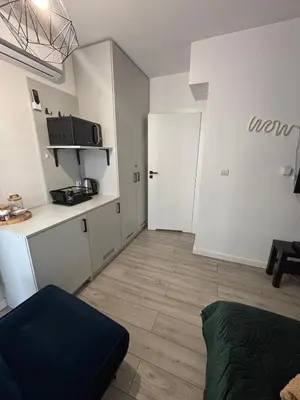 a small room with a kitchen and a door at Wow! Paradise Aparthotel in Kraków