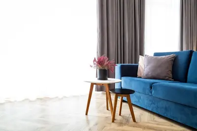 a blue couch in a living room with a table at Househost Apt - Rakowicka 20H in Kraków