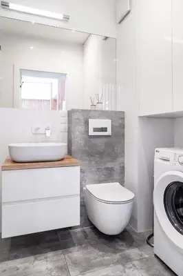 a bathroom with a toilet and a sink and a washing machine at Househost Apt - Rakowicka 20H in Kraków