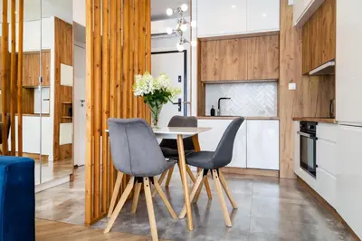 a kitchen with a table and two chairs at Househost Apt - Rakowicka 20H in Kraków